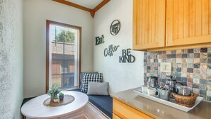 A cozy kitchen with wooden cabinets, a tiled backsplash, and a breakfast bar. - Historic Craftsman Home 3 Mi to Fort Sill N Lawton (Lawton)