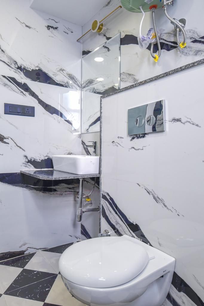 A bathroom with a white toilet, a sink, and a shower area.