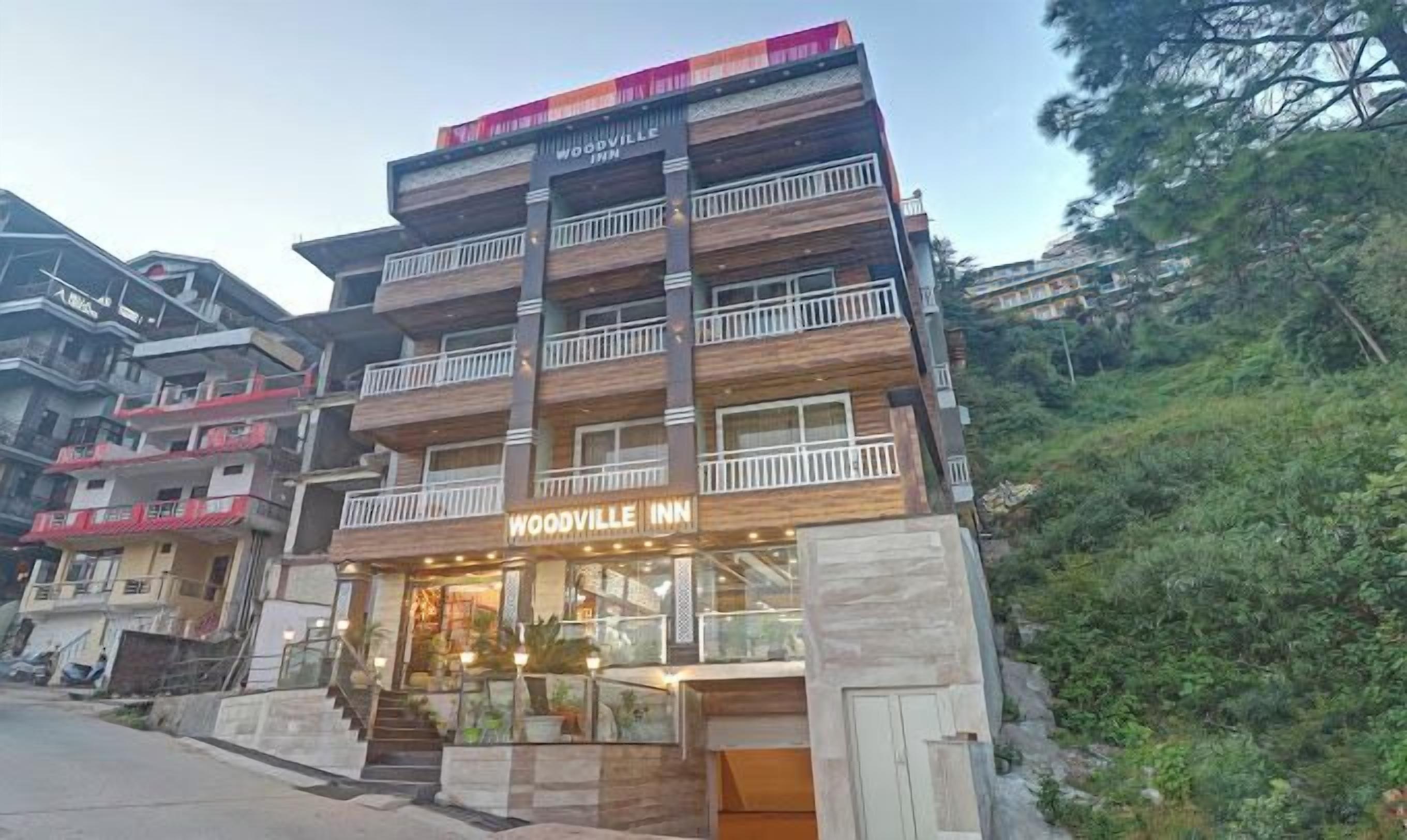 A multi-story building with the sign "Woodville Inn" indicating it is a hotel.