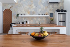 Enjoy cooking and dining in this well-equipped kitchen with a sink, refrigerator, and appliances.