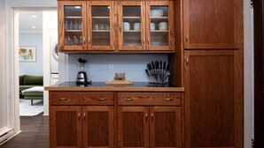 A kitchen with wooden cabinets, a countertop, a blender, and a knife block. - Fully Stocked Kitchen,  AC,  Wi-Fi, W/D,  Near Baseball and Walk to Downtown (Oneonta)