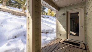 A wooden porch with a glass door leading to a bathroom. - Spotted Fawn Villa | Prime Location in Big Sky Town Center (Big Sky MT)