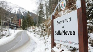 A welcome sign for Sella Nevea with a road leading into the distance and snow-covered surroundings. - Forte Family Village (Chiusaforte)