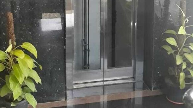 A modern elevator with a digital display showing the number 3. - Green Valley Suites (Bengaluru)