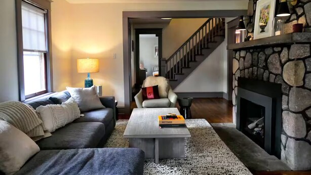 A living room with a sofa, coffee table, and fireplace. - Inviting, Cozy Catskills Home - Primed for Fall! (Shandaken)