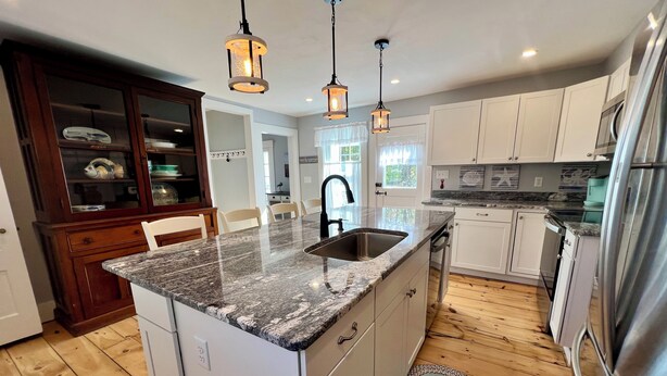 A modern kitchen with granite countertops, stainless steel appliances, and pendant lighting. - The Downing House - Newly Updated 4bd Farmhouse! (York)