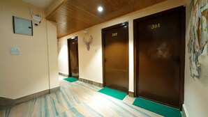 A hallway with three doors, numbered 301, 302, and 303, leading to rooms. - Hotel Triratna (Kathmandu)