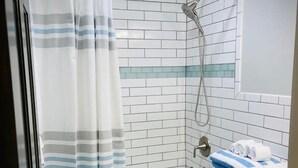 Un baño con ducha, inodoro y lavamanos.