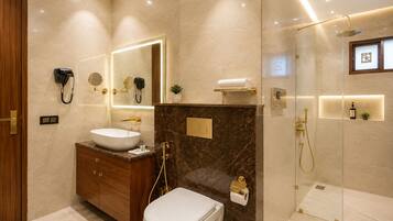 A modern bathroom with a vanity, toilet, and shower area.