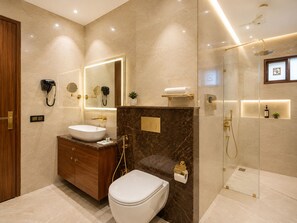 A modern bathroom with a vanity, toilet, and shower area. - Hotel Le Premier (New Delhi)