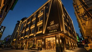 A modern hotel with a prominent 'Le Premiere Delhi' sign, large windows, and a well-lit entrance. - Hotel Le Premier (New Delhi)