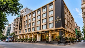 A hotel with a prominent 'Le Premier' sign, multiple floors, and a modern facade. - Hotel Le Premier (New Delhi)