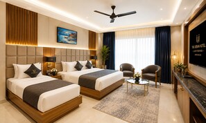 A hotel room with two beds, a ceiling fan, a TV, a desk, and a chair. - Hotel Le Premier (New Delhi)