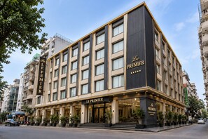 A LE PREMIER hotel with a modern facade, multiple floors, and a prominent entrance with steps leading to the lobby. - Hotel Le Premier (New Delhi)