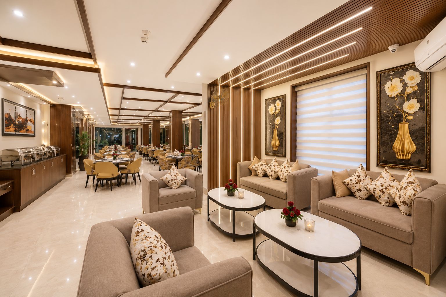 A hotel lobby with a dining area, sofas, and a reception desk.