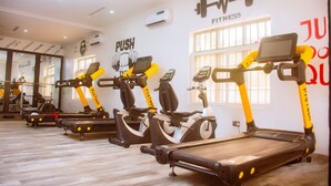A gym with treadmills, stationary bikes, and a wall with motivational fitness quotes. - Lekki Aprt/pool/gym/sleeps 6/ Freep/tv/wifi (Lekki)