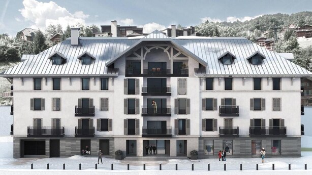 A multi-story hotel with a symmetrical facade, balconies, and a central entrance.