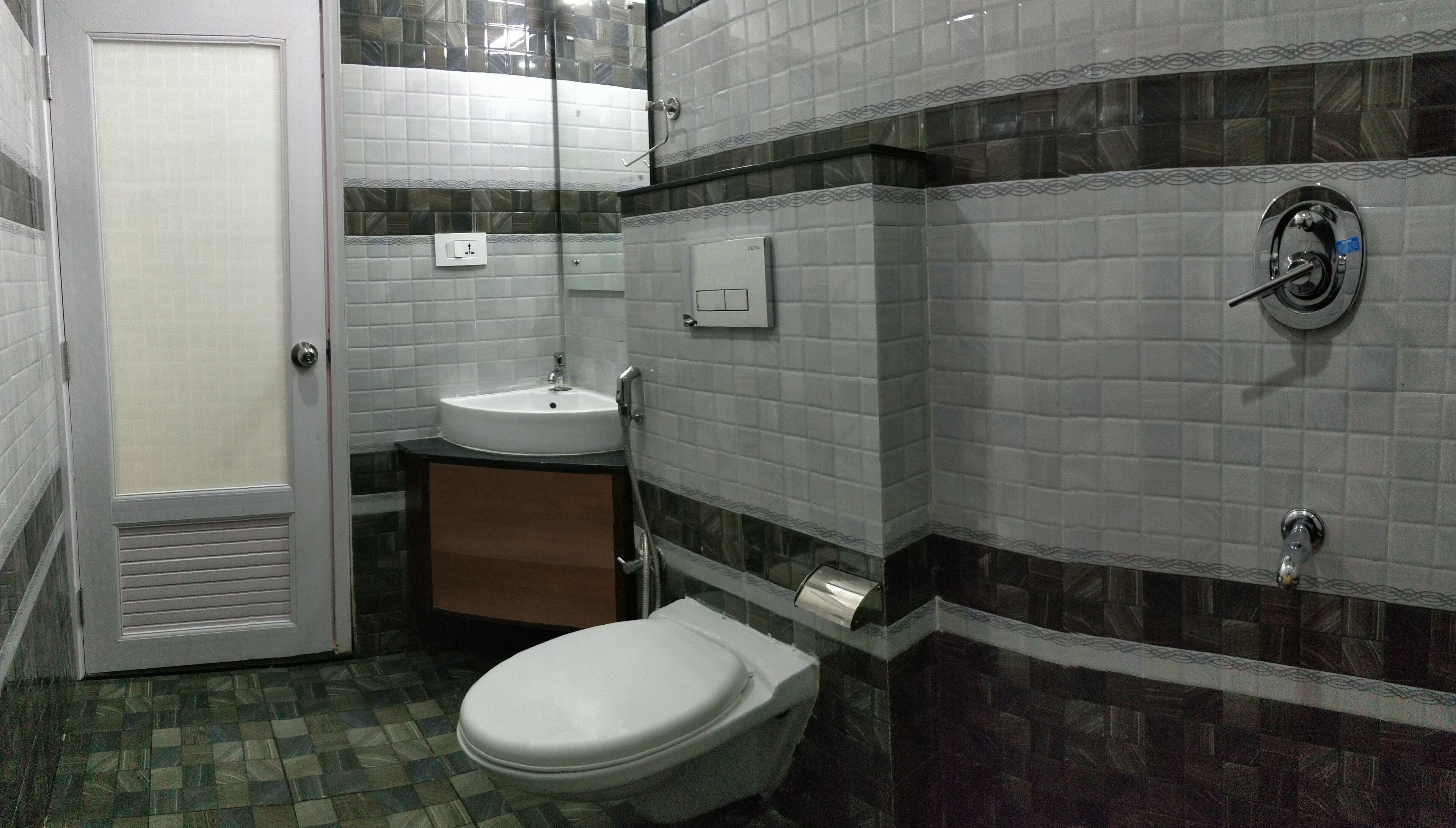 A bathroom with a toilet, sink, and shower.