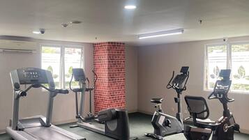 A gym with treadmills, elliptical machines, and stationary bikes.