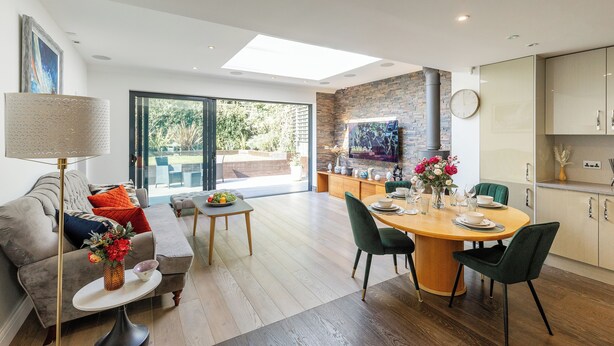 A modern living room with a sofa, coffee table, and a dining area with a table and chairs. - Apartment in Guildford with Parking (Guildford)
