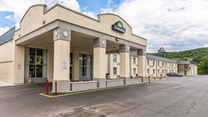 A Days Inn with a modern architectural design, featuring a flat roof and a large parking lot.