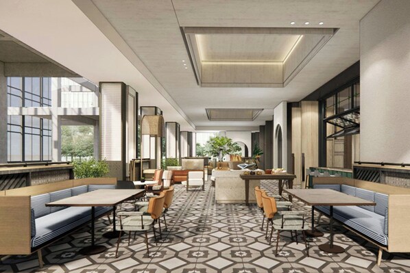 A modern indoor space with seating arrangements, a patterned floor, and large windows allowing natural light. - Courtyard By Marriott Nanning Wuxiang (Nanning)