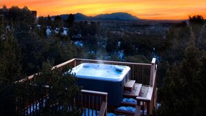 A hot tub on a wooden deck with a view of a cityscape and mountains in the background. - Jewel of Circle Drive (Santa Fe)