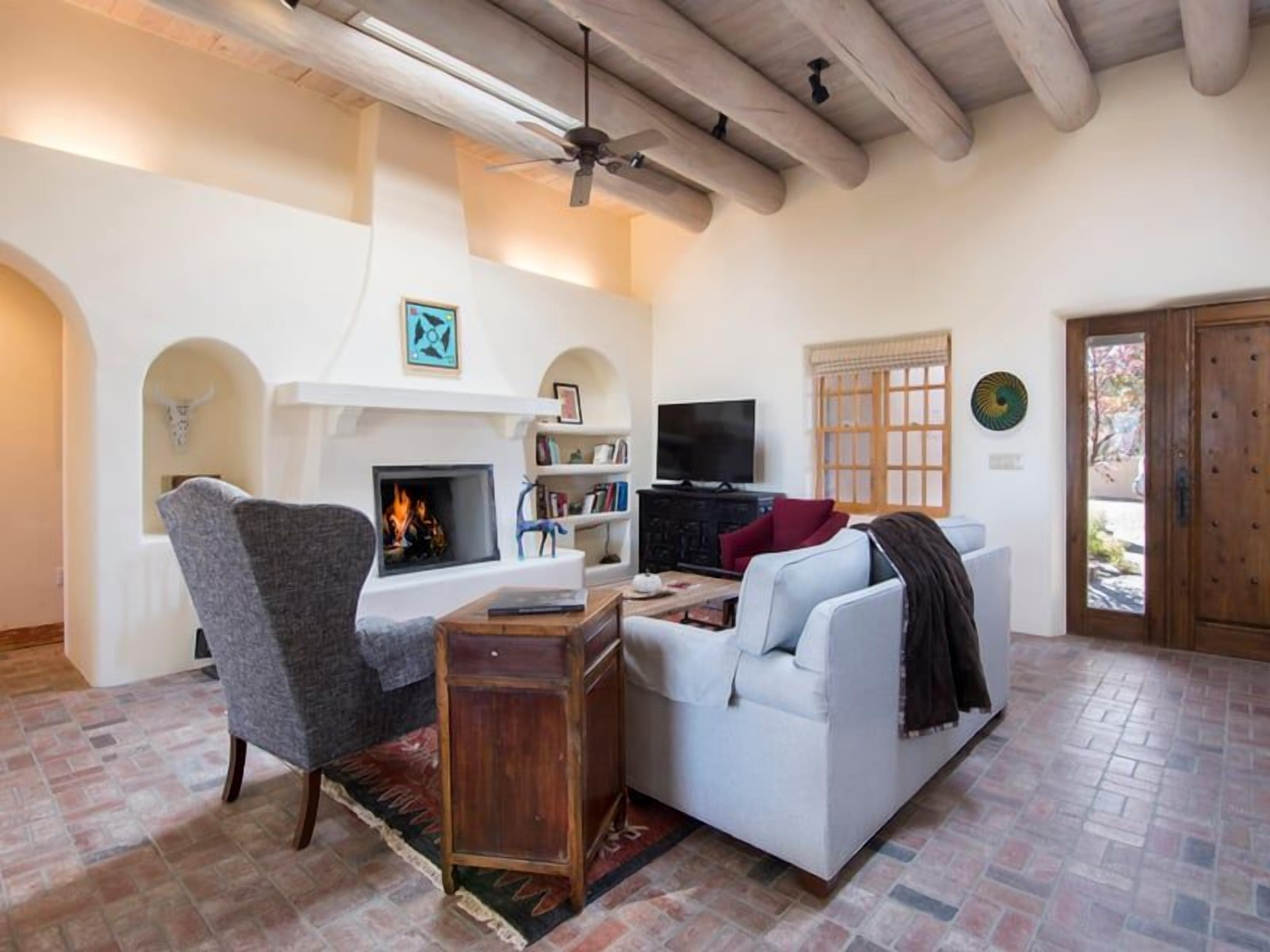 A living room with a fireplace, a television, and a sofa.