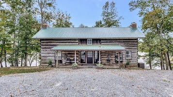 Guests can relax on the porch with seating and enjoy the natural surroundings.