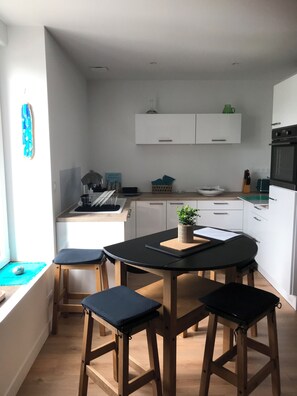 Enjoy cooking in this well-equipped kitchen with a central island, black countertop, and modern appliances.