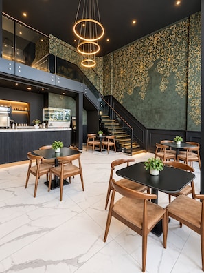A modern interior with a bar area, seating, and a staircase. - Atlantic View Appart'Hotel (Casablanca)