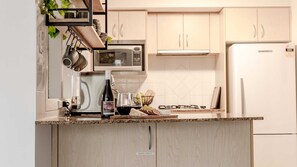 Enjoy cooking in this well-equipped kitchen with a gas stove, microwave, and sink.