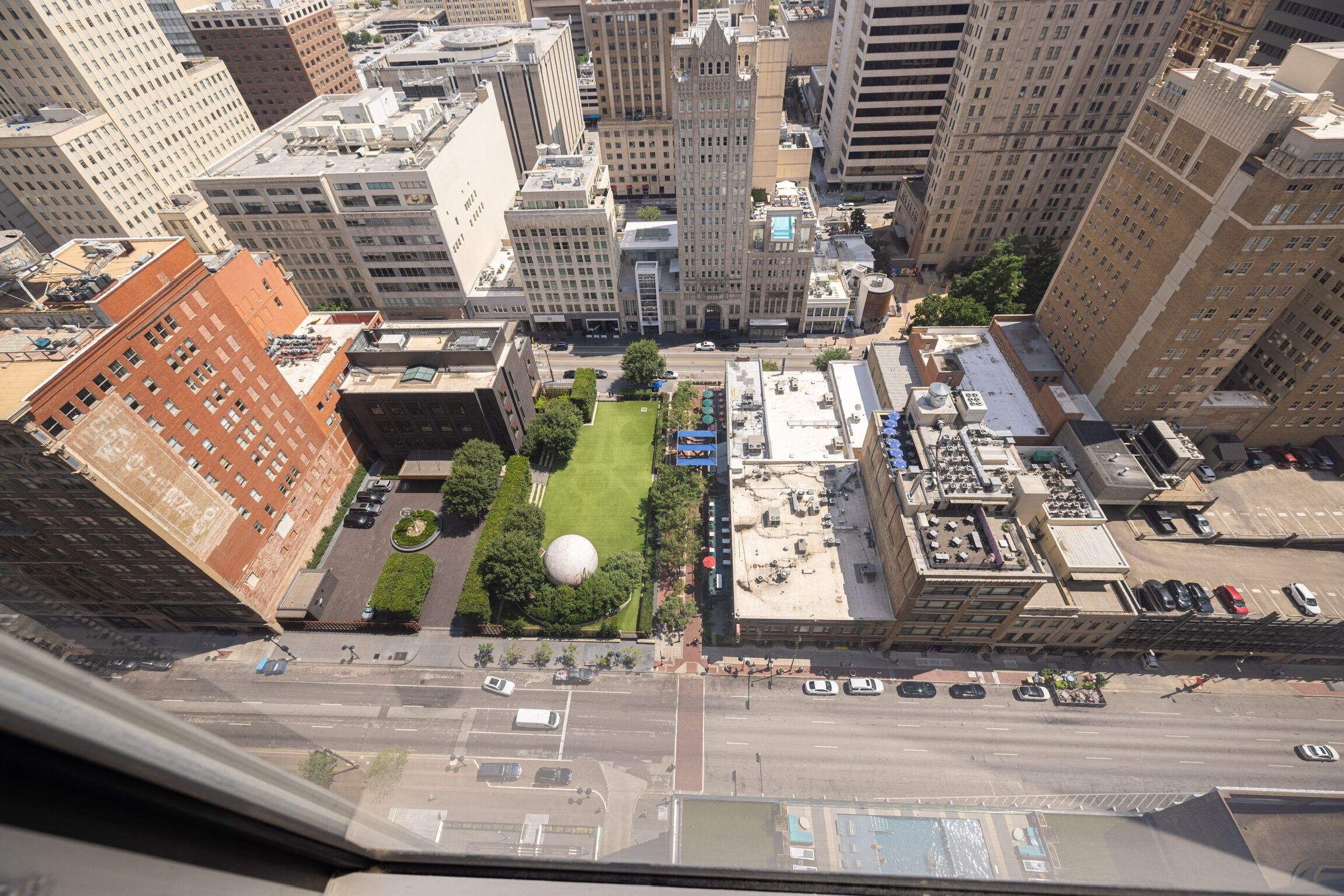 A high-rise building with a central courtyard, surrounded by other high-rise buildings.