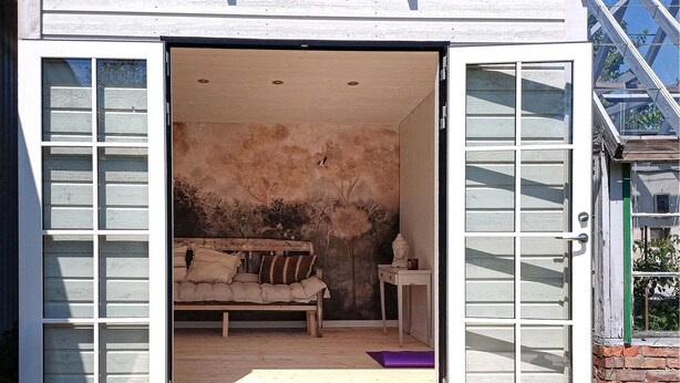 An open door to a room with a bed, a small table, and a painting on the wall. - Nice home in Härryda with WiFi (Härryda)