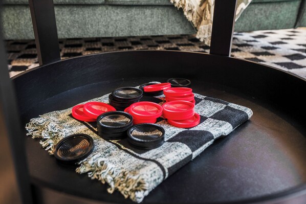 A black chair with a checkered cloth and red and black objects on it. - Htown eclectic funk vibe B (Houston)