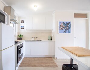 Microwave, oven, cookware/dishes/utensils, dining tables - Freo Getaway - one bedroom apartment (Fremantle)