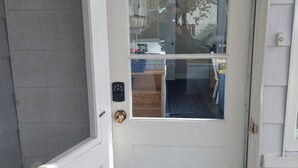 Una puerta blanca con un panel de vidrio y una cerradura electrónica.