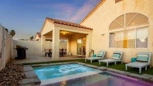 A residential property with a swimming pool, outdoor seating, and a covered patio area. - 4BR Getaway w/Pool and Billiard! (North Las Vegas)