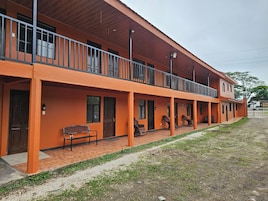 A two-story building with a balcony on the upper floor.