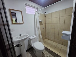 A bathroom with a sink, toilet, and shower.