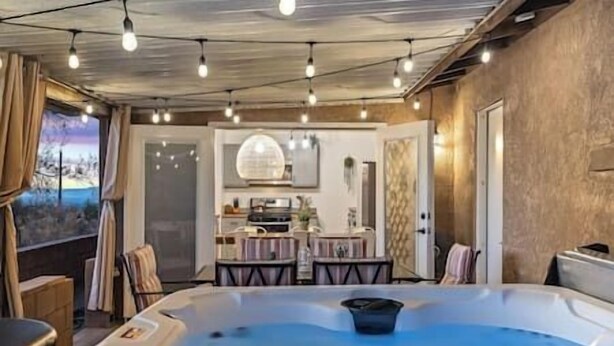 A hot tub in a room with a view of a landscape through a window. - DesertDreamscape Sauna Cold Plunge SPA 3 min to JT (Twentynine Palms)
