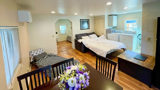 A compact, well-lit room with a bed, a desk, and a dining area. - Sunnyvale Cabin (Sunnyvale)
