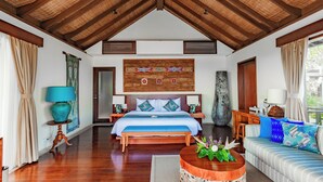 A spacious bedroom with a large bed, wooden ceiling, and a decorative wall hanging. - Villa Cantik Pandawa By Fays Hospitality (Kutuh)
