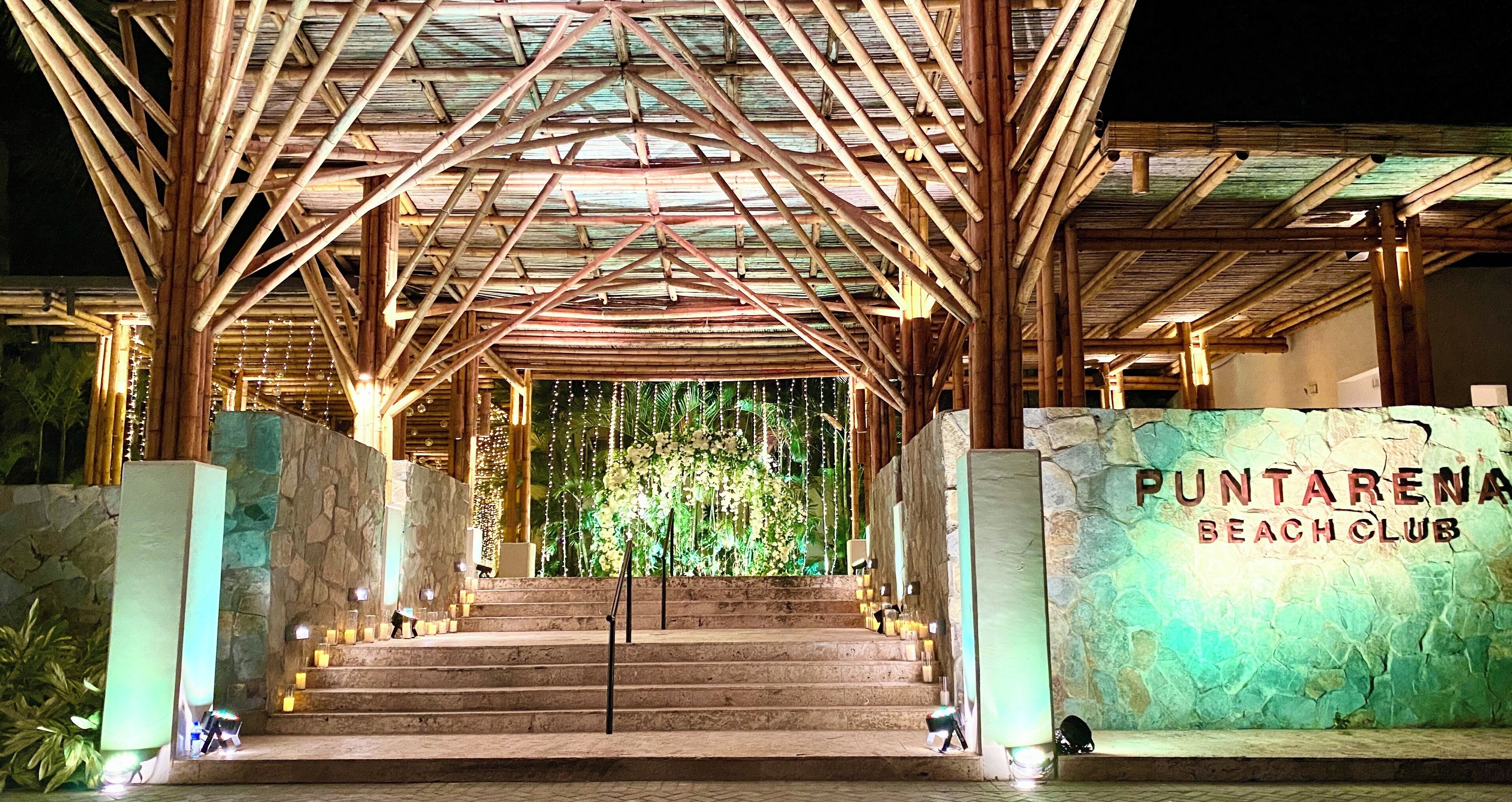 A wooden structure with a sign reading "Puntarena Beach Club".