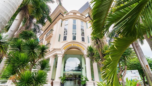 A building with a grand entrance, large columns, and a symmetrical facade.