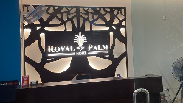 A reception desk with a modern design, featuring a logo for 'Royal Palm Hotel'. - Hotel Royal Palm (Sylhet)