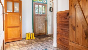 A wooden door with a glass panel, a wooden door with a green frame, and a wooden door with a diagonal design.