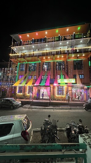 A hotel with multiple floors, balconies, and a sign for the hotel and banquet hall.