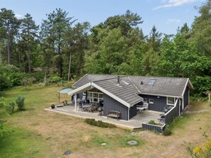 A two-story house with a covered patio, a deck, and a large yard. - "Tyyne" - 250m from the sea by Interhome (Sjællands Odde)