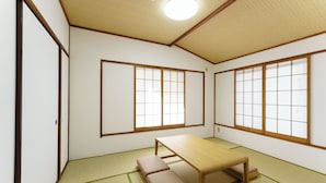 Una habitación japonesa tradicional con suelo de tatami, una mesa de madera baja y puertas correderas shoji.